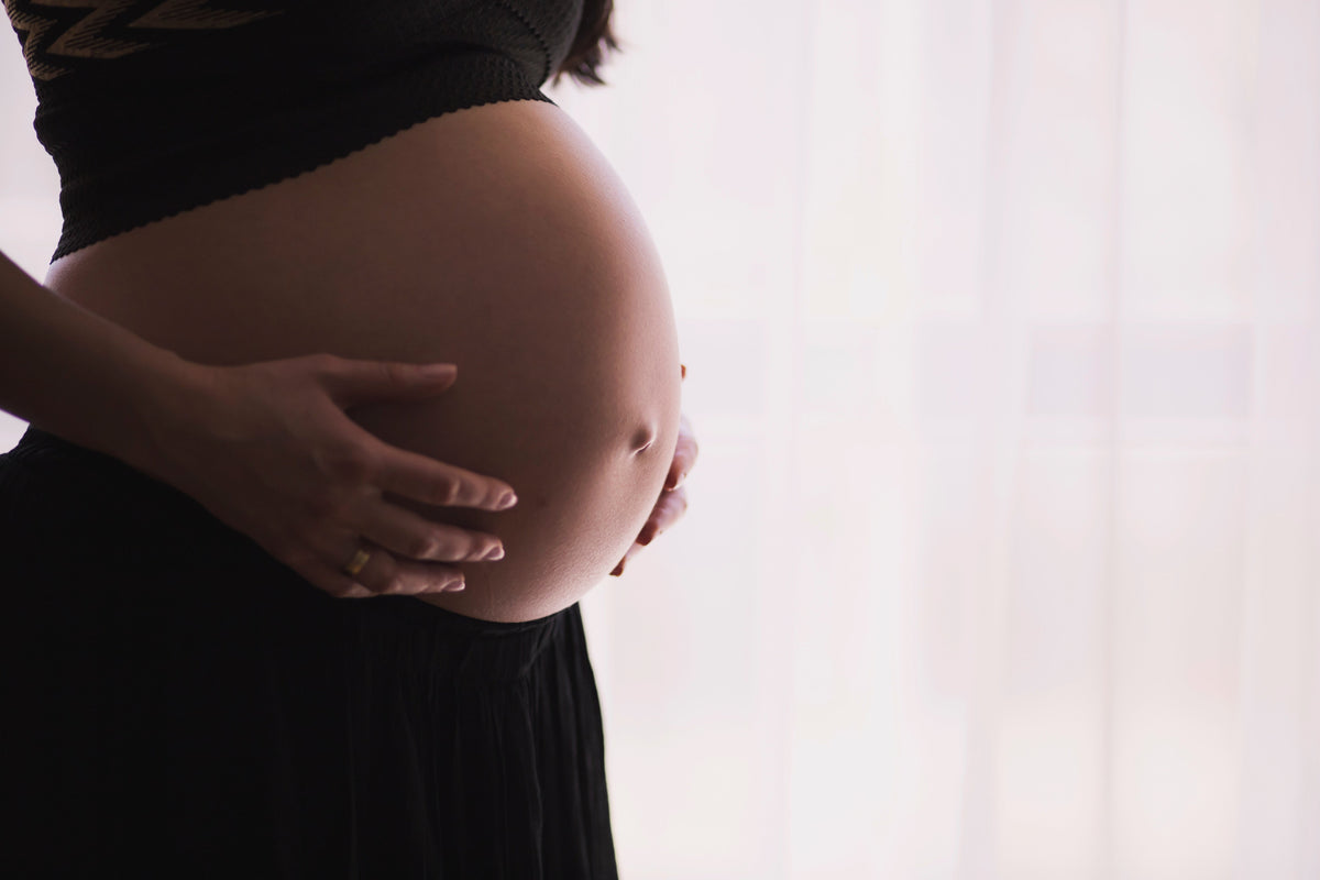 Pregnant woman resting with legs elevated to improve circulation