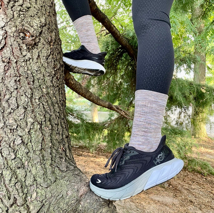 Purple and brown outdoor compression socks on the trail