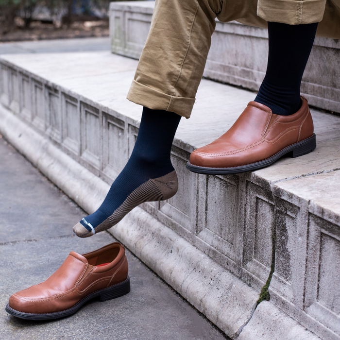 Men's compression socks worn in a lifestyle photo.