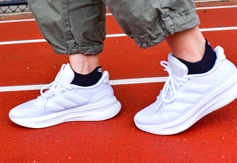 Runner lacing up with compression socks — Dr. Motion blog cover