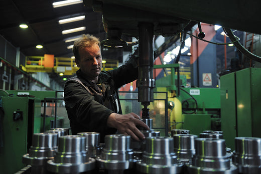 Factory worker on a long shift wearing compression socks — Dr. Motion blog cover