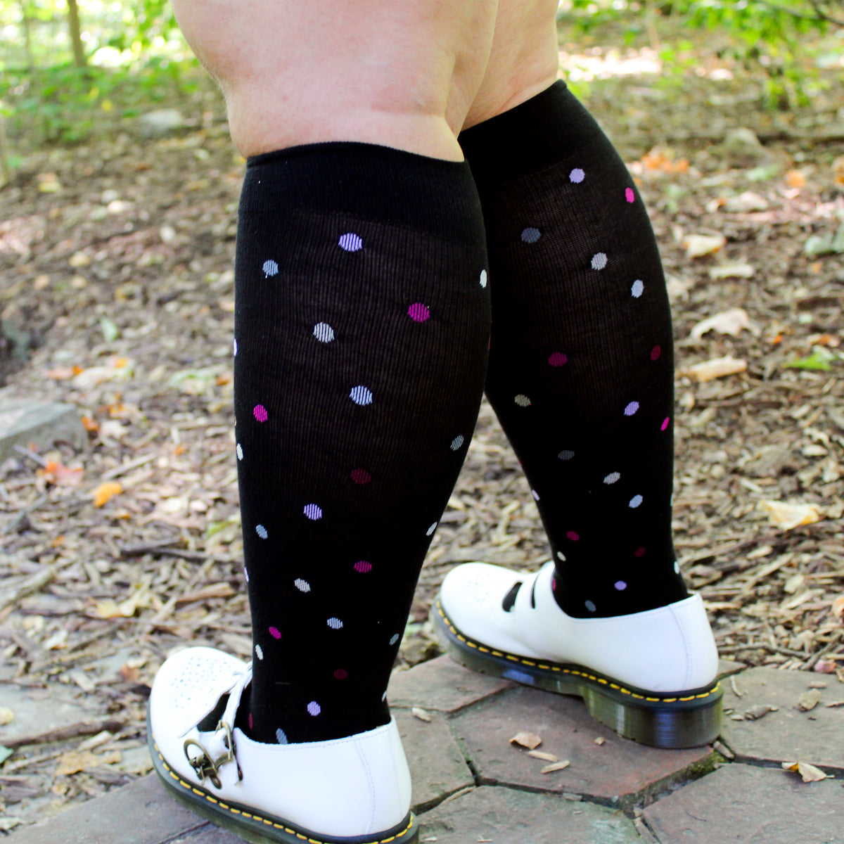 Black wide-calf knee-high compression socks worn in an everyday setting
