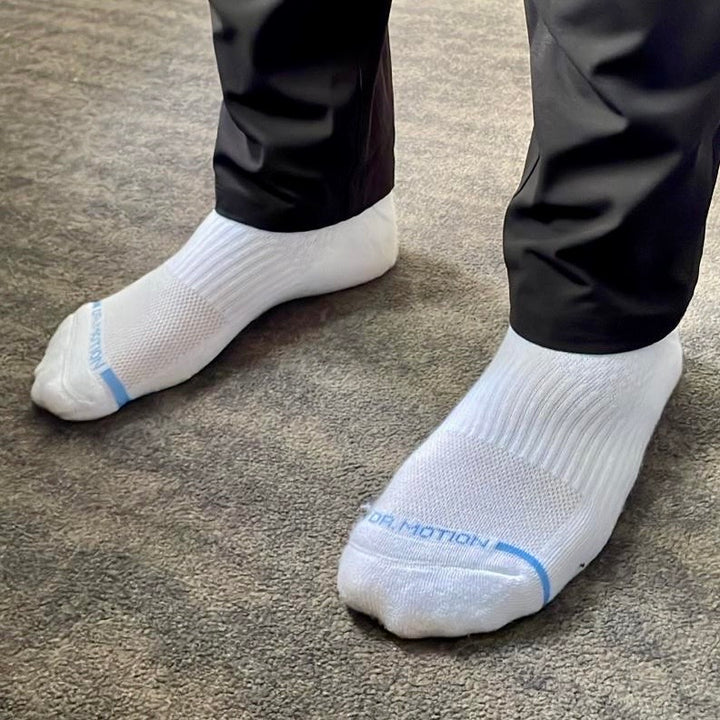 White quarter compression socks worn in a lifestyle setting.