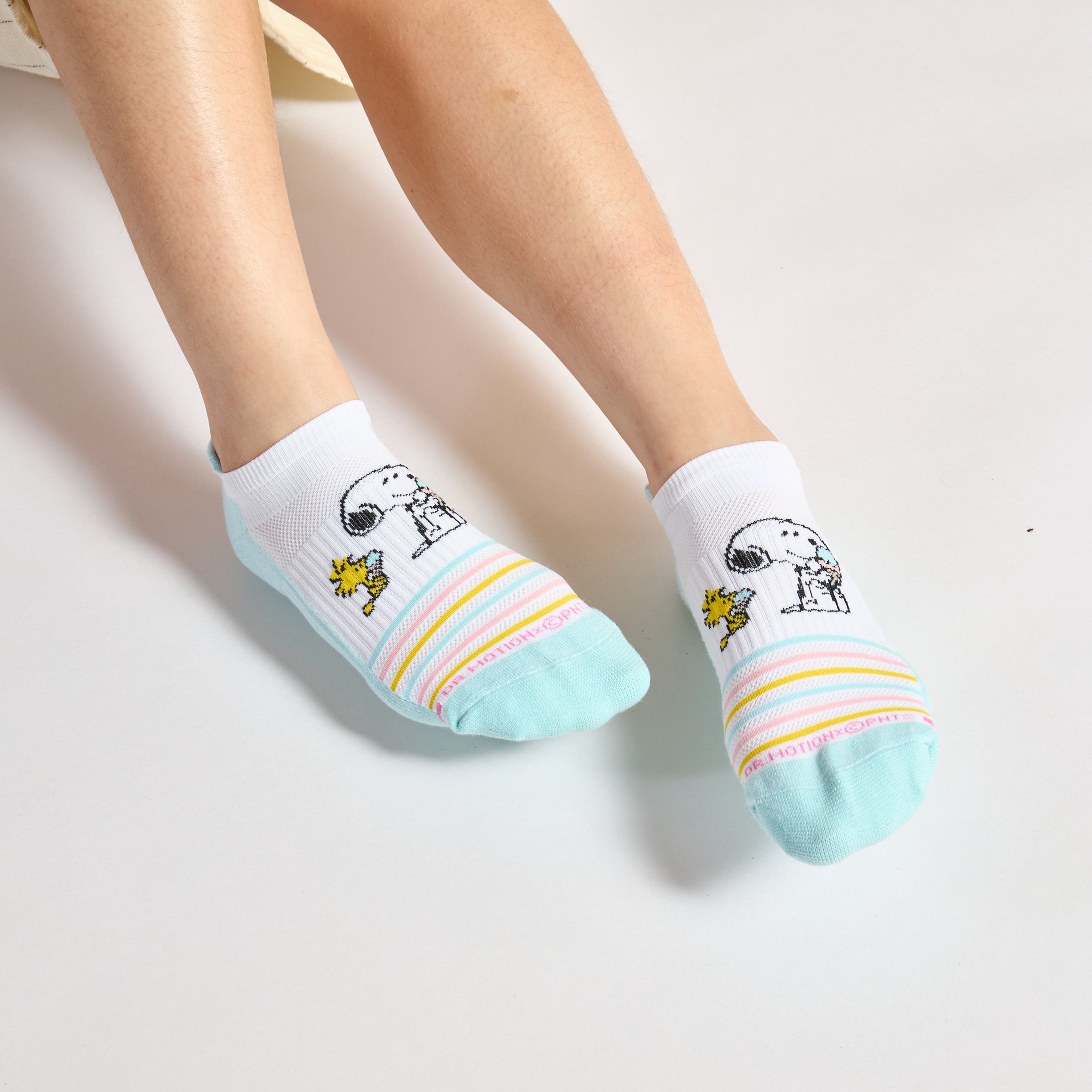 Ankle compression socks featuring Snoopy and Woodstock with a colorful striped design.
