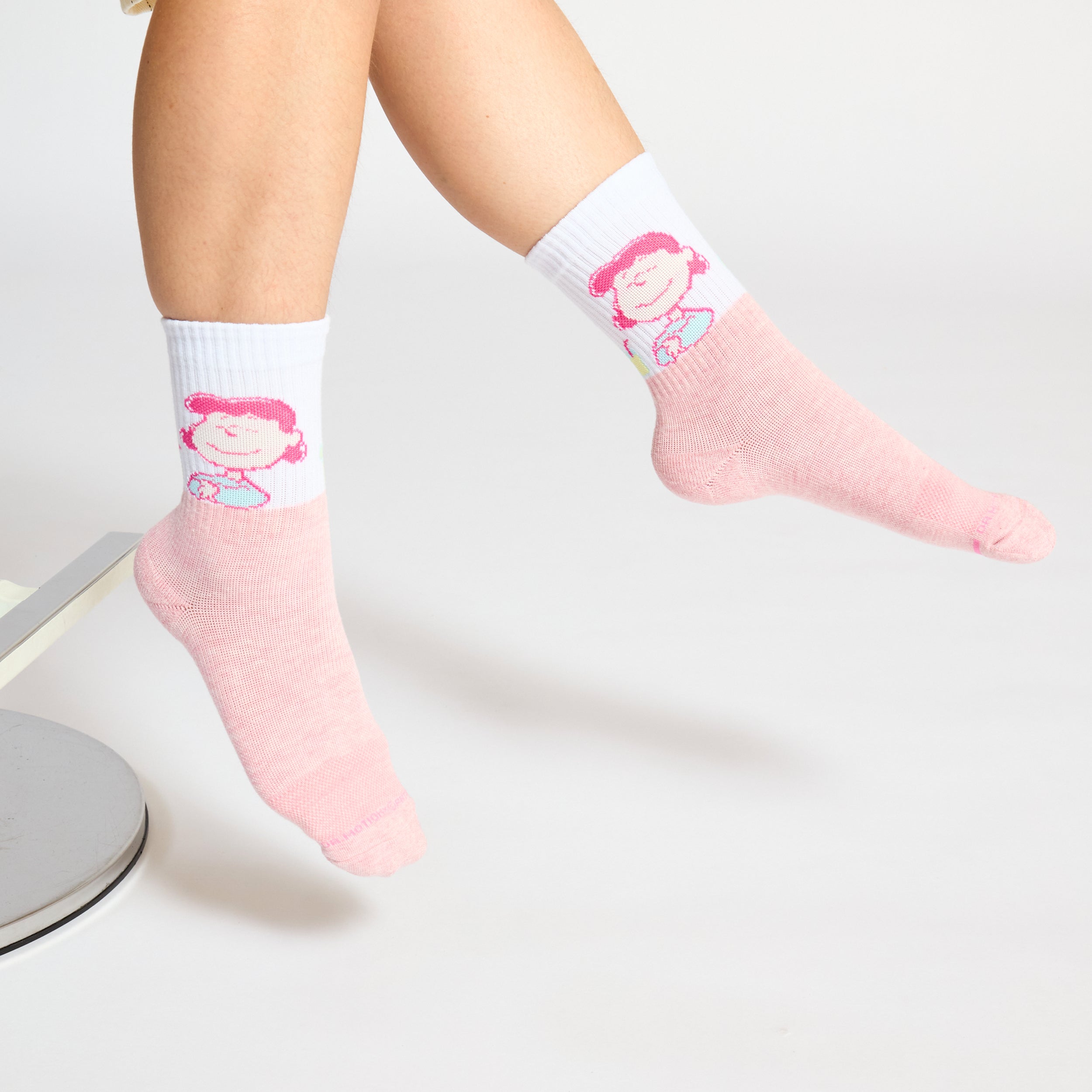Mid-crew compression socks featuring a pink and white design with a cartoon character on the upper section.