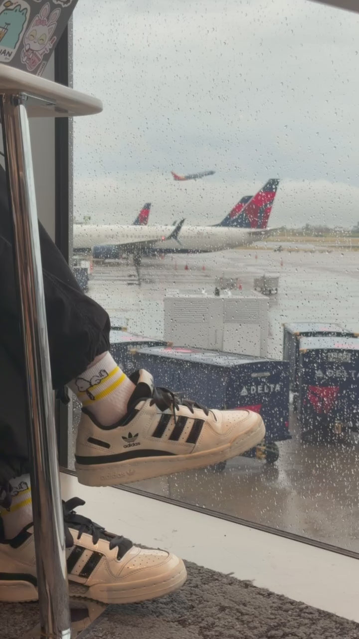 Video: airport tarmac seen through a rainy terminal window
